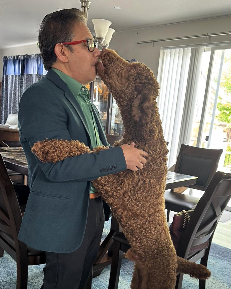 Manoj with Mocha, the family dog